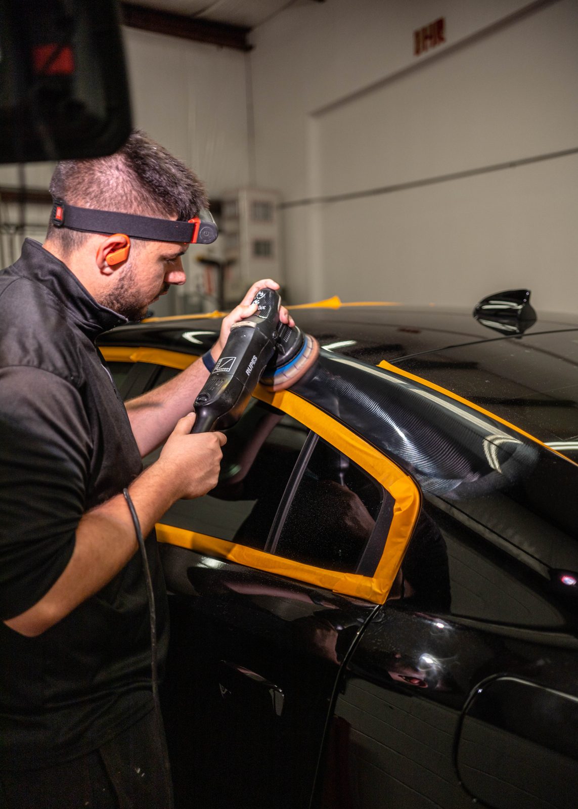 Obsidian detailer applying a protective treatment to a large panel near Chapel Hill